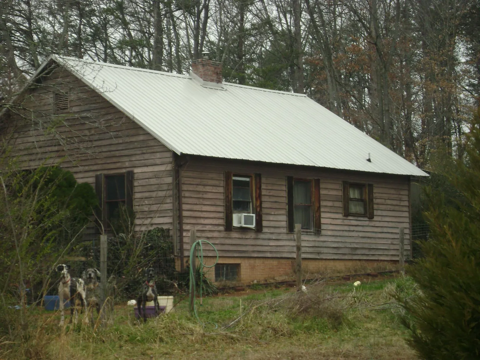 White metal roof on an old wood sided farmhouse, from a Metal Roof Installation job in London